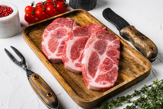 Fresh raw pork neck meat set, on white stone table background