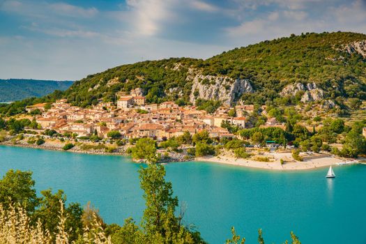 The city on the bank of the artificial lake in France, Provence, lake Saint Cross, gorge Verdone, azure water of the lake and slopes of mountains on a background, small boats, vacations place. High quality photo