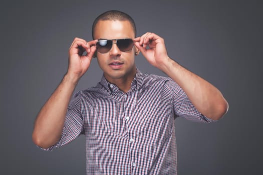 Shot of a handsome young man fashionably posing against a studio background.