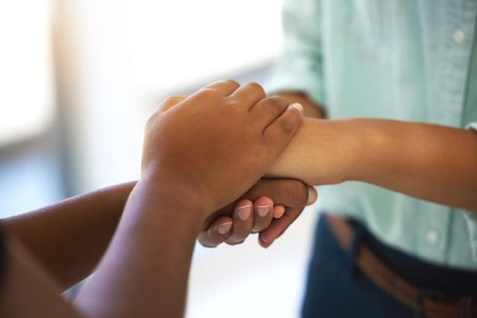 Cropped shot of two unrecognizable people holding hands.