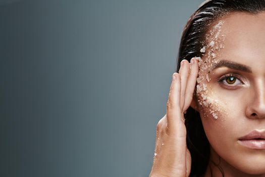 Shot of a beautiful young woman posing with salt on her face.