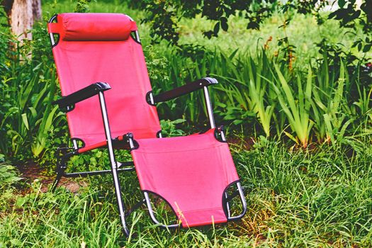 an upholstered armchair that can be tilted backward, especially one with a footrest that simultaneously extends from the front.