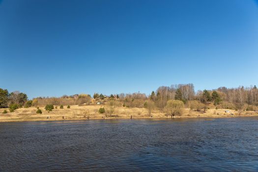 A lot of fishermans fishing with a rod on the shore of river Neman. Grodno, Belarus