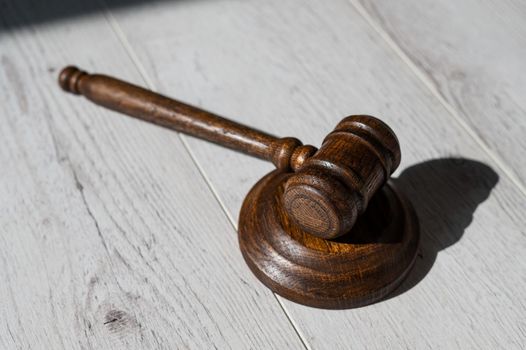 Wooden judicial gavel on a wooden laminate