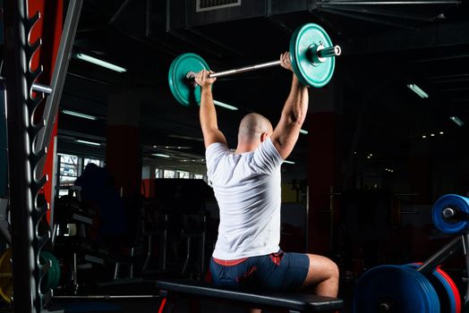 Man in the gym lifts the barbell. bodybuilding and healthy lifestyle