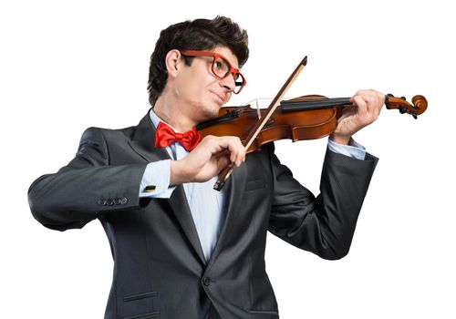 Young musician with glasses plays the violin. Smiles and enjoys