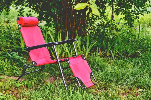 an upholstered armchair that can be tilted backward, especially one with a footrest that simultaneously extends from the front.