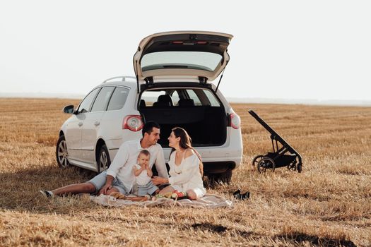 Weekend Road Trip with Car, Young Family with Toddler Child Enjoying Picnic Outside City, Mom and Dad Dressed Alike with Their Daughter