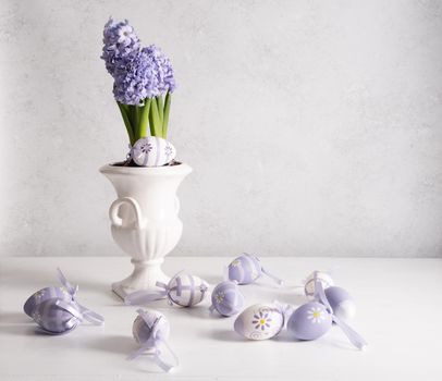 Easter eggs and Lilac hyacinth in a vase, spring still life, copy space. High quality photo