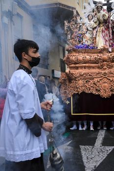 Elche, Spain- April 13, 2022: Easter Parade with altar boys and penitents through the streets of Elche city in the Holy Week