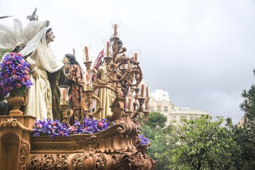 Elche, Spain- April 13, 2022: Easter Parade with bearers and penitents through the streets of Elche city in the Holy Week