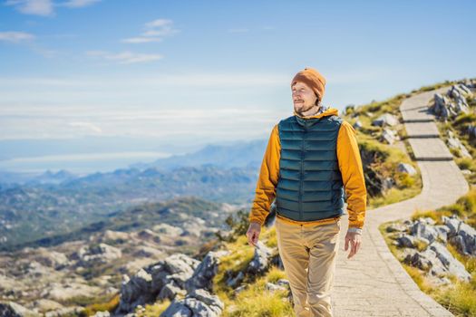 Man traveller in mountain landscape at national park Lovcen, Montenegro. Travel to Montenegro concept.