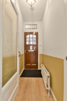 Corridor leading to a residential apartment with a parquet floor and carpet in a cozy house