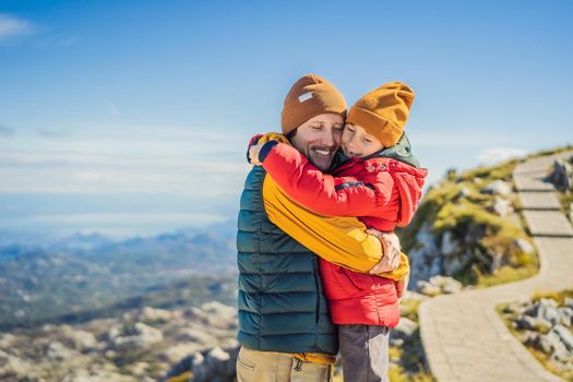 Dad and son travellers in mountain landscape at national park Lovcen, Montenegro. Travel to Montenegro with children concept.