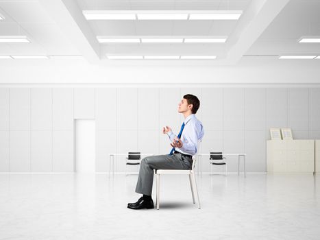 young businessman in the office meditates, achieve calmness, to achieve the goal