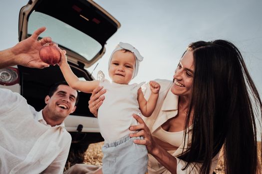 Close Up Portrait of Young Family, Mother and Father with Their Toddler Daughter Having Fun Time Outdoors During Their Road Trip with Car