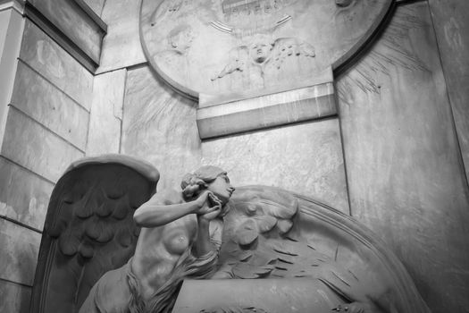 GENOA, ITALY - June 2020: antique statue of angel (beginning 1900, marble) in a Christian Catholic cemetery - Italy