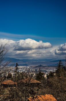 Spring view to Tbilisi city with blue sky and white clouds
