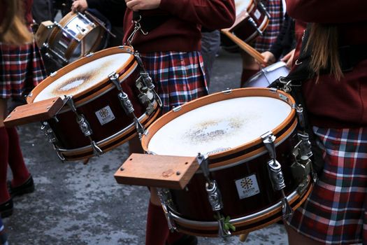 Elche, Alicante, Spain- April 10, 2022: Children Musicians in red uniform going out in procession in The Holy Week of Elche