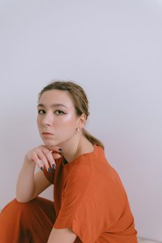 Portrait of young caucasian woman in red cloth. Dreamy