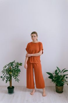 Portrait of young caucasian woman in red cloth. Dreamy