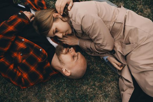 young couple laying on grass. summer love outdoors
