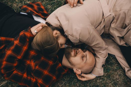 young couple laying on grass. summer love outdoors