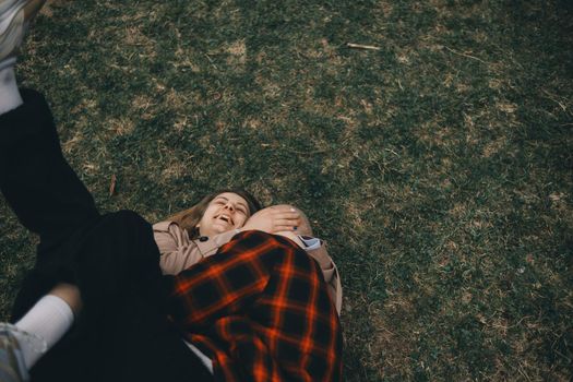 young couple laying on grass. summer love outdoors