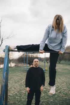 man and woman having fun on the playground in the park