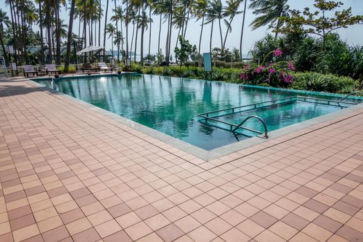 Pool and palm trees beach resort