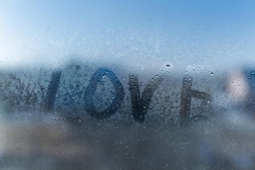 word love on a foggy window.