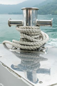 Mooring post on small boat on beautiful green water