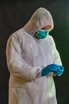 Man in chemical suit measures toxicity levels and checks for contamination