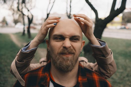 girl closes her lover's eyes from behind. hipster