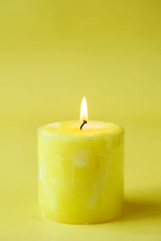 yellow color candles slowly burning down