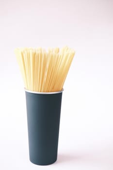 Yellow long spaghetti in a container on table ,