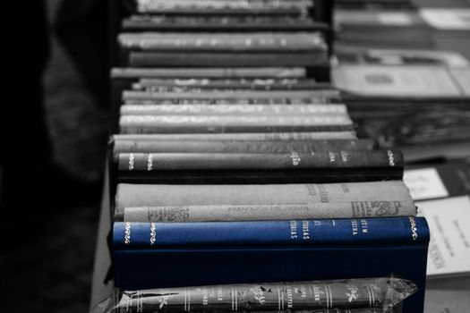 Some books in a street market in Lisbon Portugal. Blue color is standing out