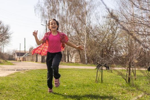 girl, child summer Sunny day walking on a green grassy meadow.