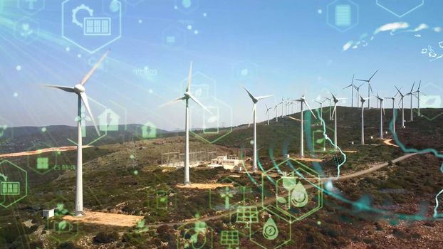 Aerial view over the farm landscape and wind turbines generating clean renewable energy. Renewable energy production for the green ecological world. High quality photo