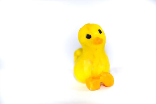 Plasticine yellow duckling. platinum toys on a white background.