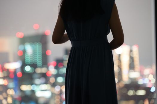 Silhouette of a night view and a woman. Shooting Location: Tokyo metropolitan area