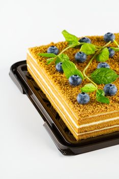 Honey cake with berries close up. Honey cake with blueberries and mint