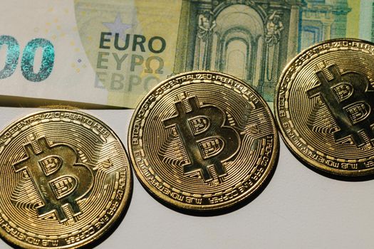 Bitcoin on banknotes of one hundred euro. Exchange euro for bitcoin. Cryptocurrency on euro bills. Digital modern method of payment. Concep of virtual money.