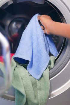 putting towel and cloths in a washing machine