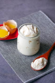 Mayonnaise in container , oil and eggs on table ,