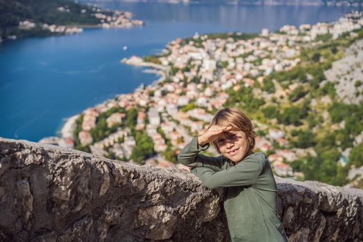 Boy tourist enjoying Colorful street in Old town of Kotor on a sunny day, Montenegro. Travel to Montenegro concept.