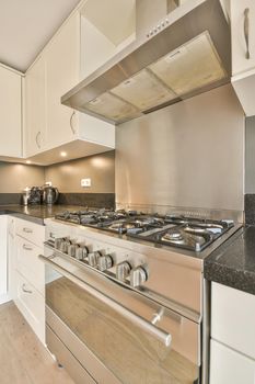 Kitchen hood and gas stove in a cozy kitchen close-up