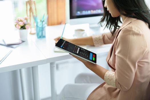 Financial and investment planning concept, female businesswoman using computer to analyze charts to find entry points on a trading board. through digital media via the internet