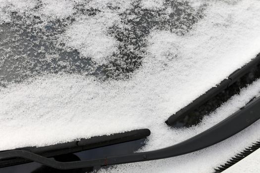 Close up of Graupel Snow pellets on a Windshield of a Vehicle, formed when supercooled water droplets Freeze onto Snow Crystals. High quality photo