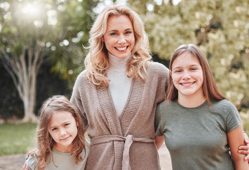 Shot of a woman spending time outdoors with her two daughters.